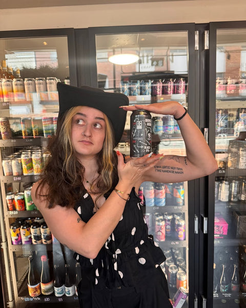 Jade Dawson shows off a can of Bring It Home in front of the Siren RG1 beer fridge.